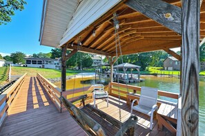 A wooden deck with a gazebo, benches, and a view of a pond and boats. - Private Dock & Lake Norman Access! Family Home (Mooresville)