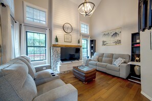 A spacious living room with a fireplace, a large flat-screen TV, and comfortable seating. - 5 Mi to Toyota Music Factory! Unit w/ Pool Access (Irving)