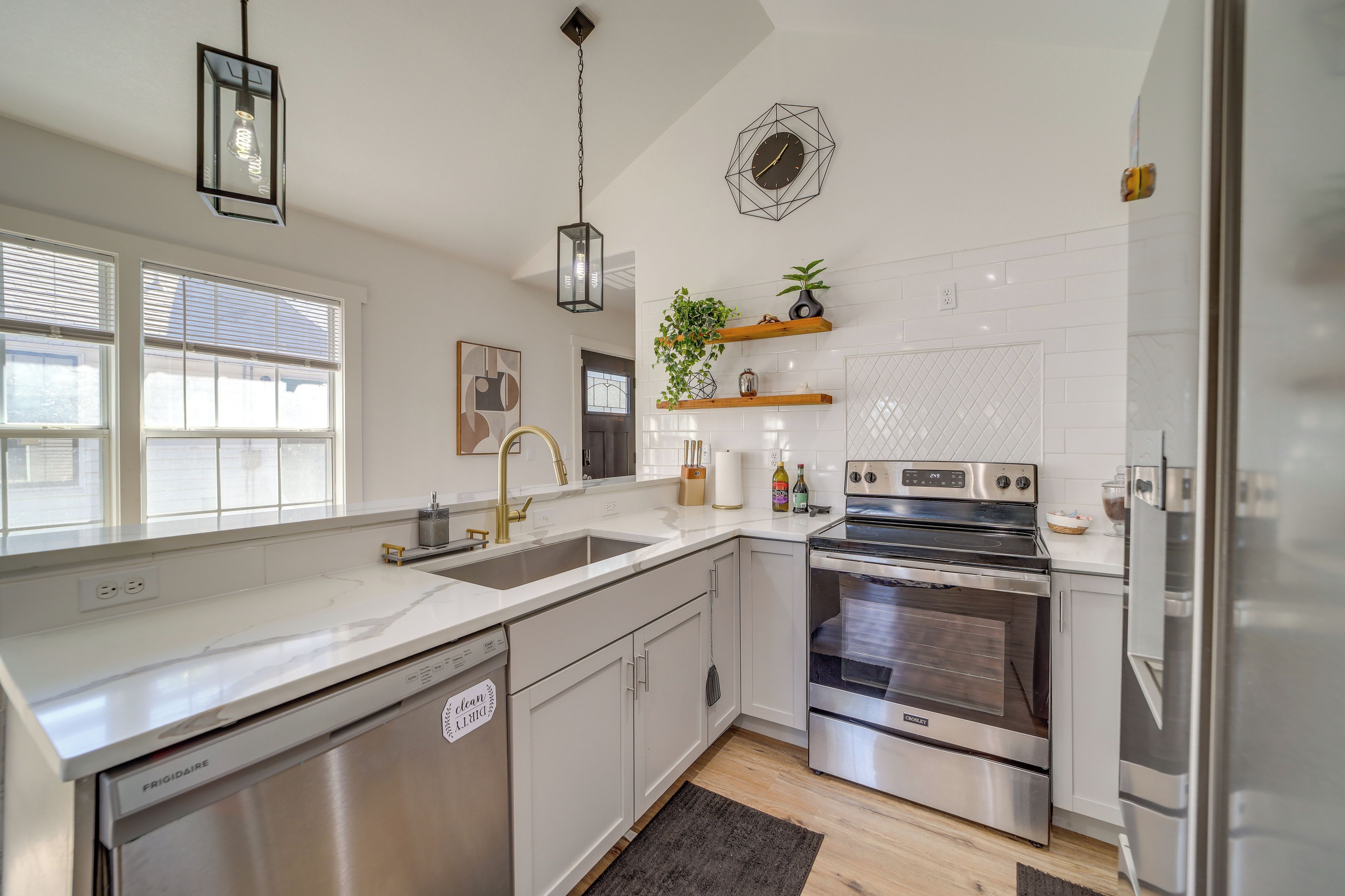 A modern kitchen with stainless steel appliances, a dishwasher, and a built-in oven.