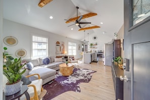A modern living room with a sofa, coffee table, and a cowhide rug. - Walk to Cherry Street Shops & Eats! Tulsa Escape (Tulsa)