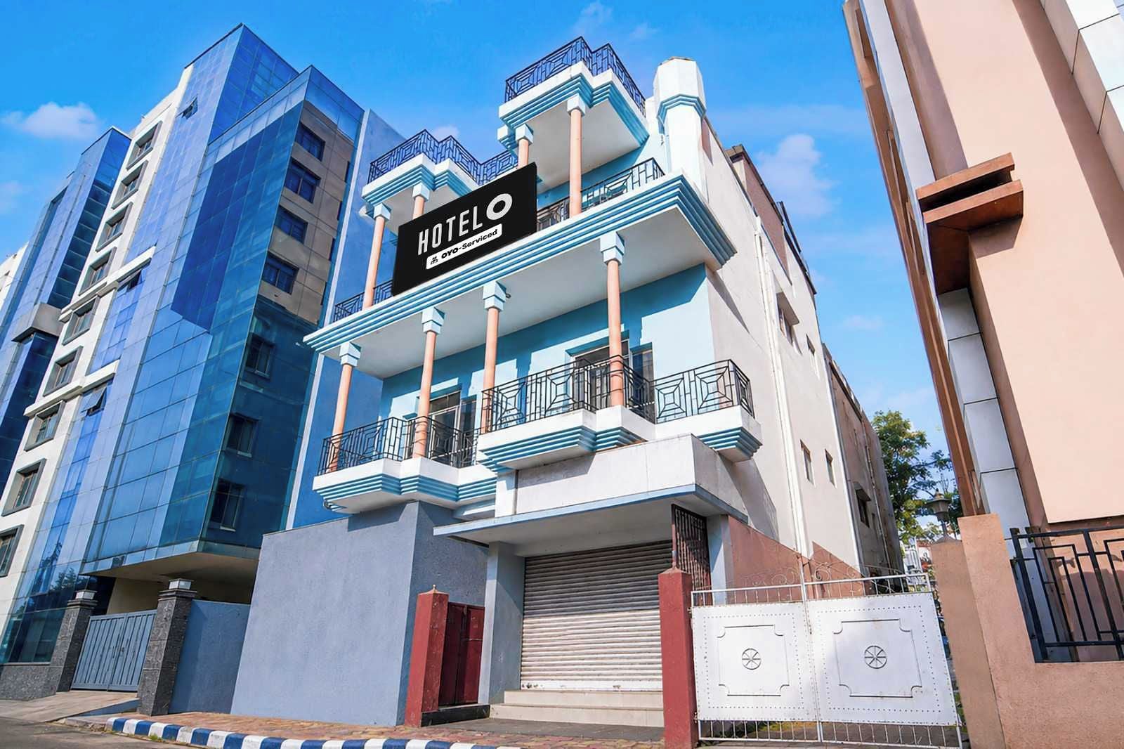 A hotel building with a sign that reads 'HOTEL OYO-Serviced.'