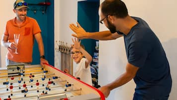 Een tafelvoetbaltafel in een kamer met blauwe wanden en een deur.