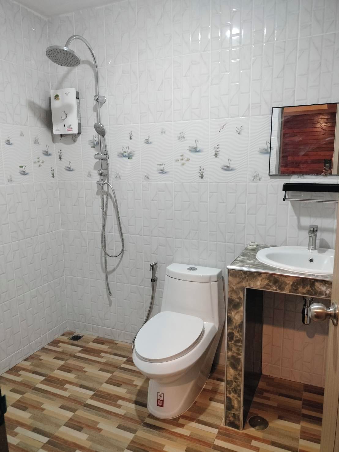 A bathroom with a shower, toilet, and sink.