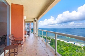A balcony with a view of the ocean, a pool, and a beach. - Portofino 2-1101 🌊🌅 11th Floor Gulf Views | Gulf Front Pool + Sauna (Pensacola Beach)