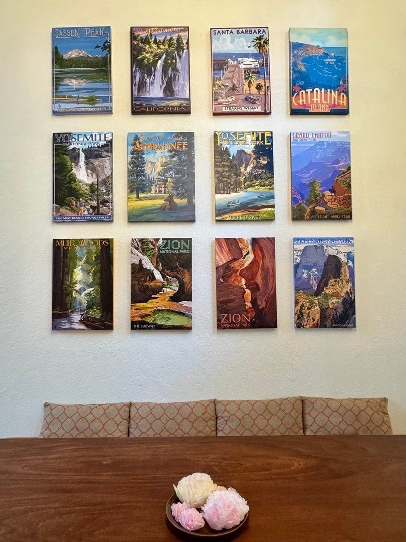 A wall with a series of travel posters.
