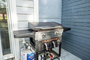 A portable propane grill with a control panel, a gas tank, and a metal grill grate. - Relax In Charlottesville Sauna Full Home Gym 2 Bedroom Home (Charlottesville)
