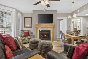 A modern living room with a fireplace, a television, and comfortable seating. - Premium Unit 3313 - One Bedroom w/Full Kitchen- Fraser Crossing/Founders Pointe 1 Condo (Winter Park)