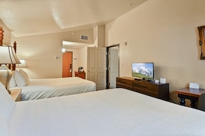 A hotel room with two beds, a television, a dresser, and a door leading to a bathroom. - Villa 3054 2 Bed 2 Bath Full Kitchen 2 Bedroom Villa (Midway)
