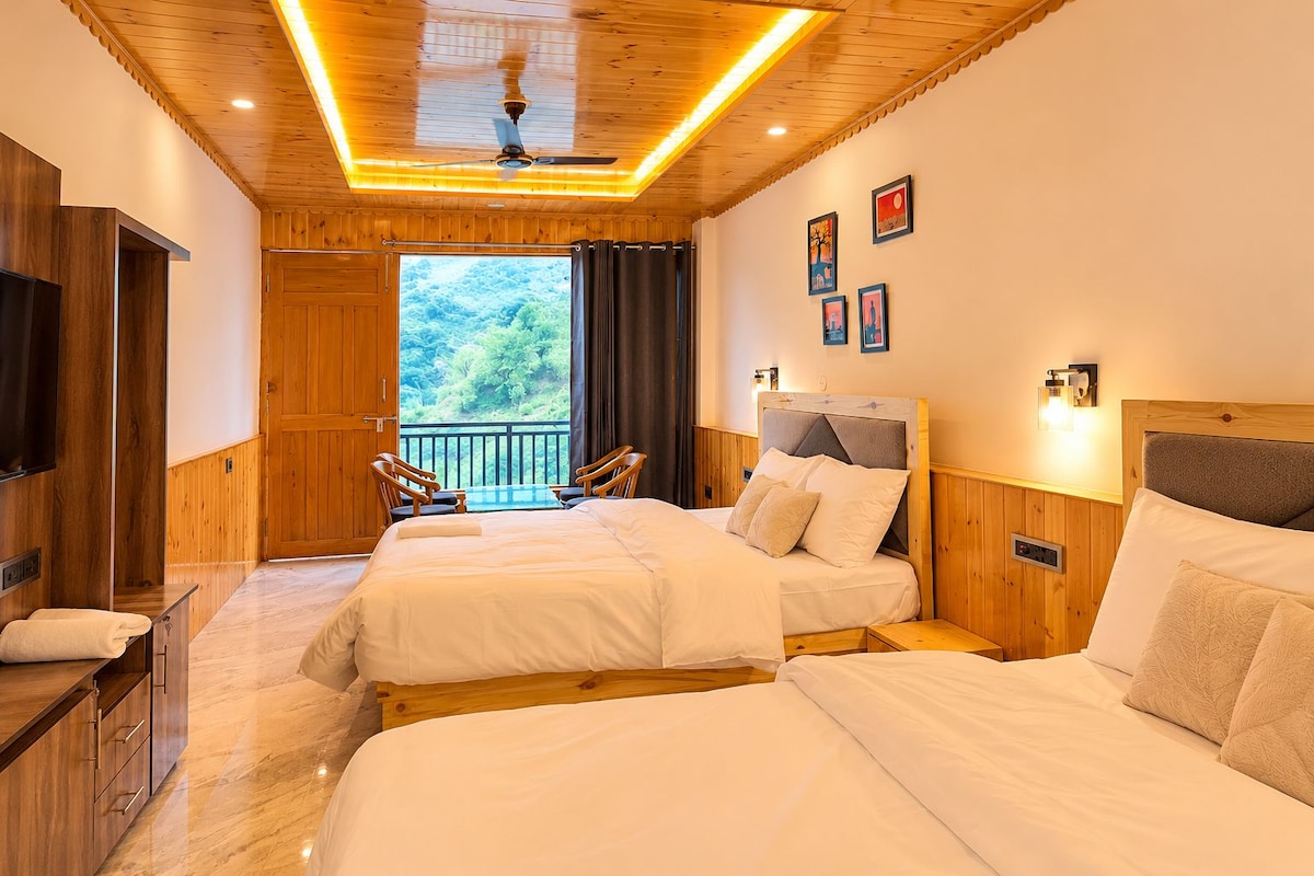 A hotel room with two beds, a TV, a balcony, and a wooden ceiling.