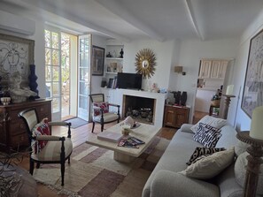 A living room with a fireplace, a television, and a sofa. - Bastide de l'Aven with a pool—within walking distance of Aups, in an olive grove (Aups)