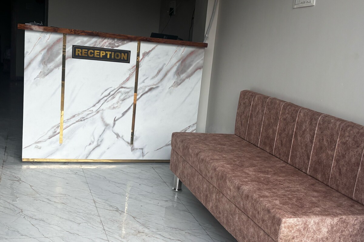 A reception desk with a marble finish and a sign that reads 'RECEPTION.'
