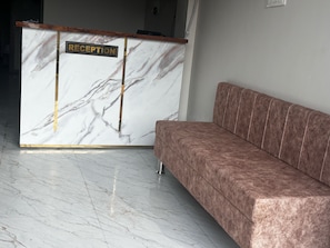 A reception desk with a marble finish and a sign that reads 'RECEPTION.' - Collection O Jantar Mantar Ujjain (Ujjain)