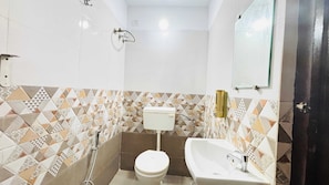 A small bathroom with a toilet, sink, and shower. - Collection O Jantar Mantar Ujjain (Ujjain)