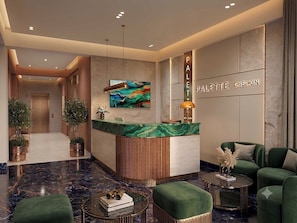 A lobby with a reception desk, seating area, and a wall-mounted sign. - Palette Hotel and Resort Mayapur (Mayapur)