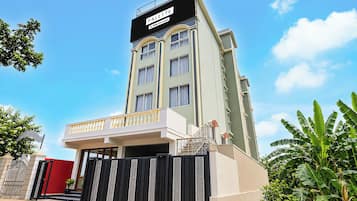 A multi-story hotel with a prominent sign reading 'PALETTE' and 'OYO-Serviced'.