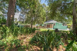 A small, single-story building with a sloped roof, surrounded by dense vegetation and trees. - Iconic Coastal retreat close to Siesta Key Beach! (Sarasota)