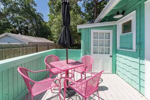 Porch: Relax outdoors in a comfortable seating area, perfect for morning coffee, casual conversations, or unwinding in the fresh air after a day of exploring. - Iconic Coastal retreat close to Siesta Key Beach! (Sarasota)
