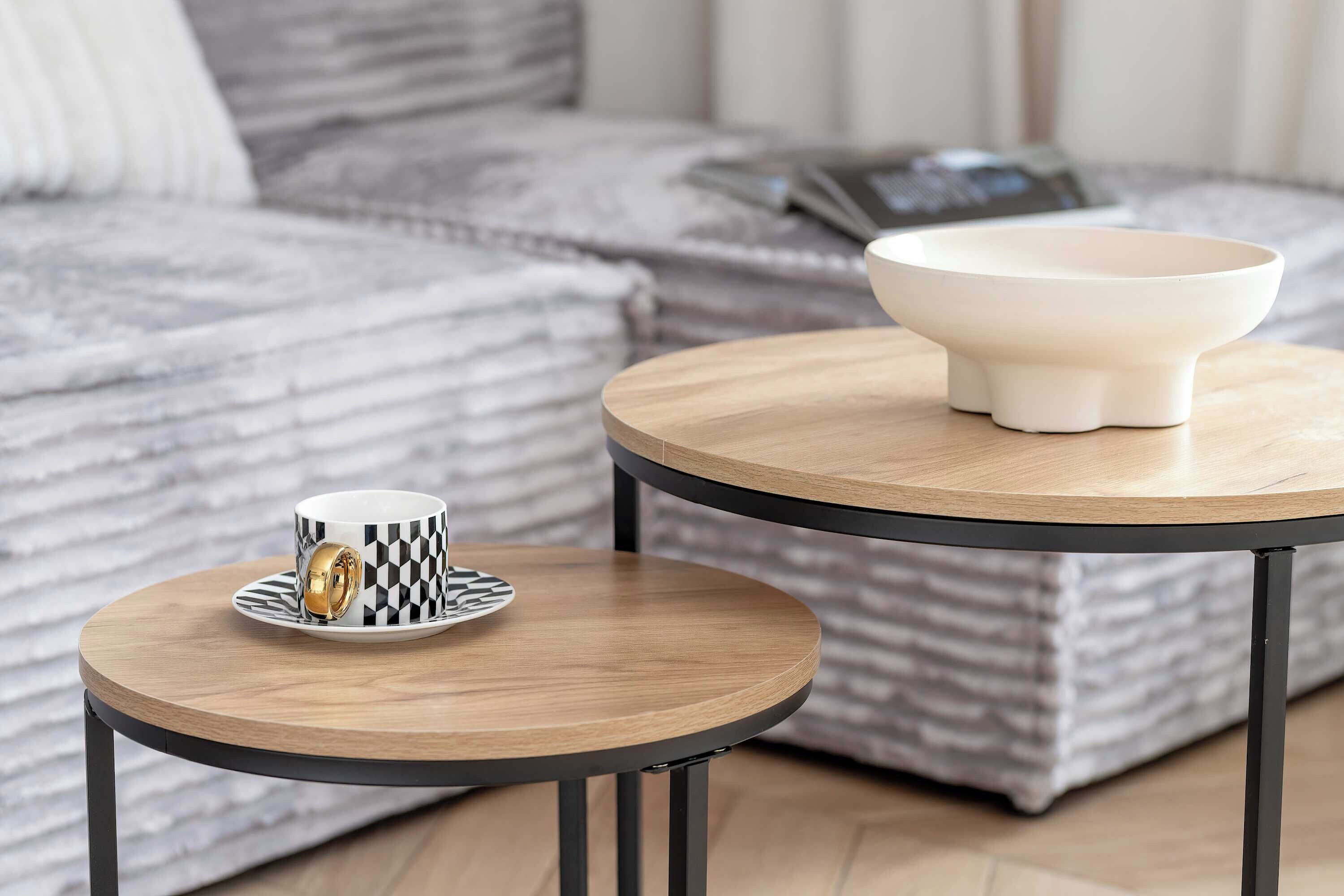 A small round table with a white bowl and a cup on a saucer.