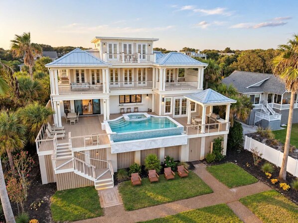 A large two-story house with a swimming pool, multiple decks, and a well-maintained lawn. - 3908 Palm Boulevard, Isle of Palms (Isle of Palms)
