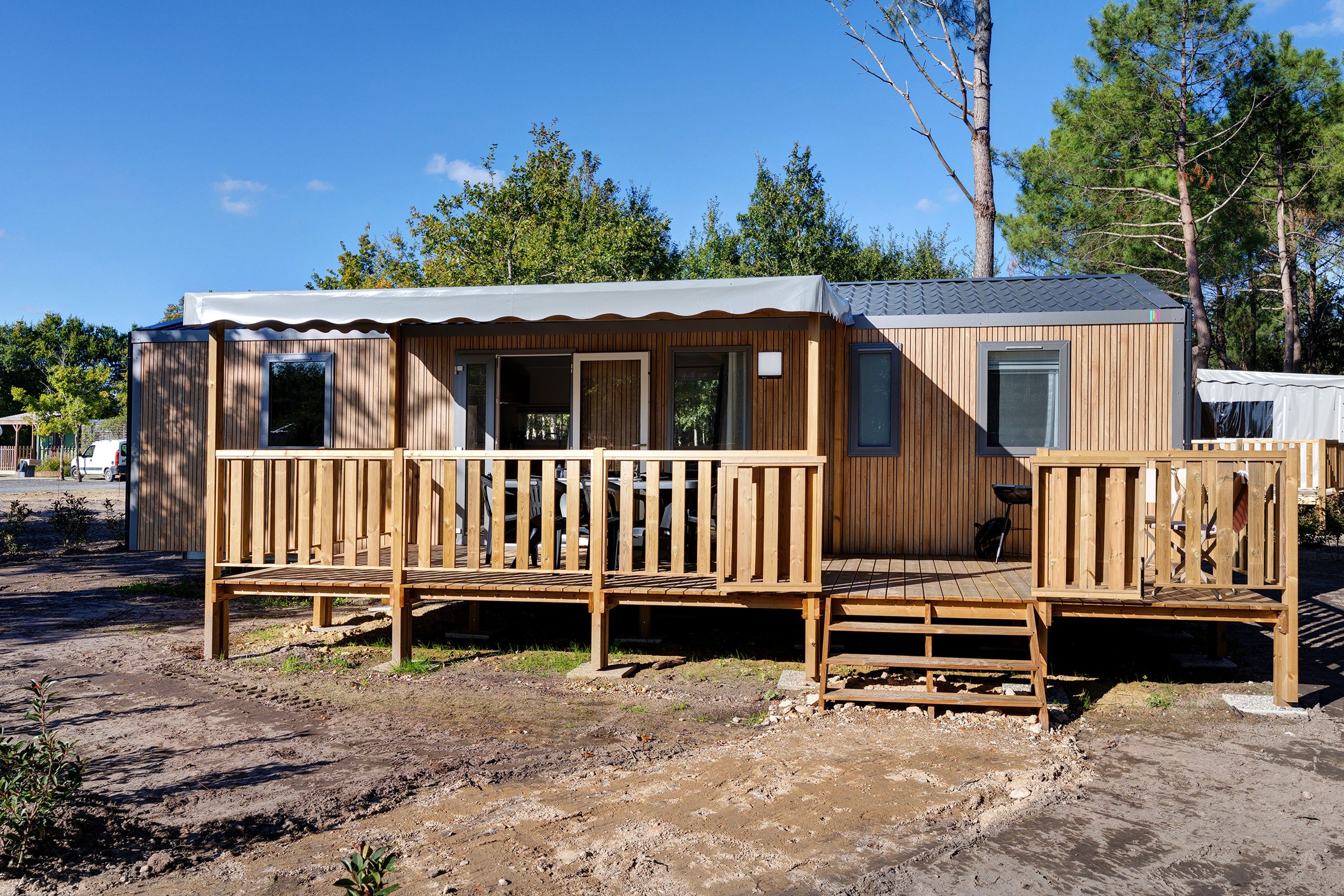 Een houten hut met een veranda en een overdekt terras.