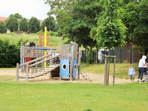 A playground with climbing structures and slides. - Apartment 'Petronela' with Lake View, Private Terrace and Wi-Fi (Waren (Müritz))
