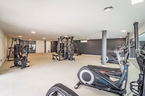 A gym with various exercise equipment including treadmills, elliptical machines, and weight machines. - LMe133A- Stunning flat close to beach in estepona (Estepona)