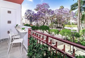 A balcony with white chairs, a small table, and a railing. - TErr69- Bright city gem in charming Old Town (Estepona)
