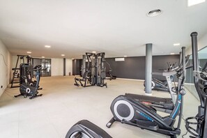 A gym with various exercise equipment including treadmills, elliptical machines, and weight machines. - LME9F2 - top class flat in Estepona, near beach (Estepona)