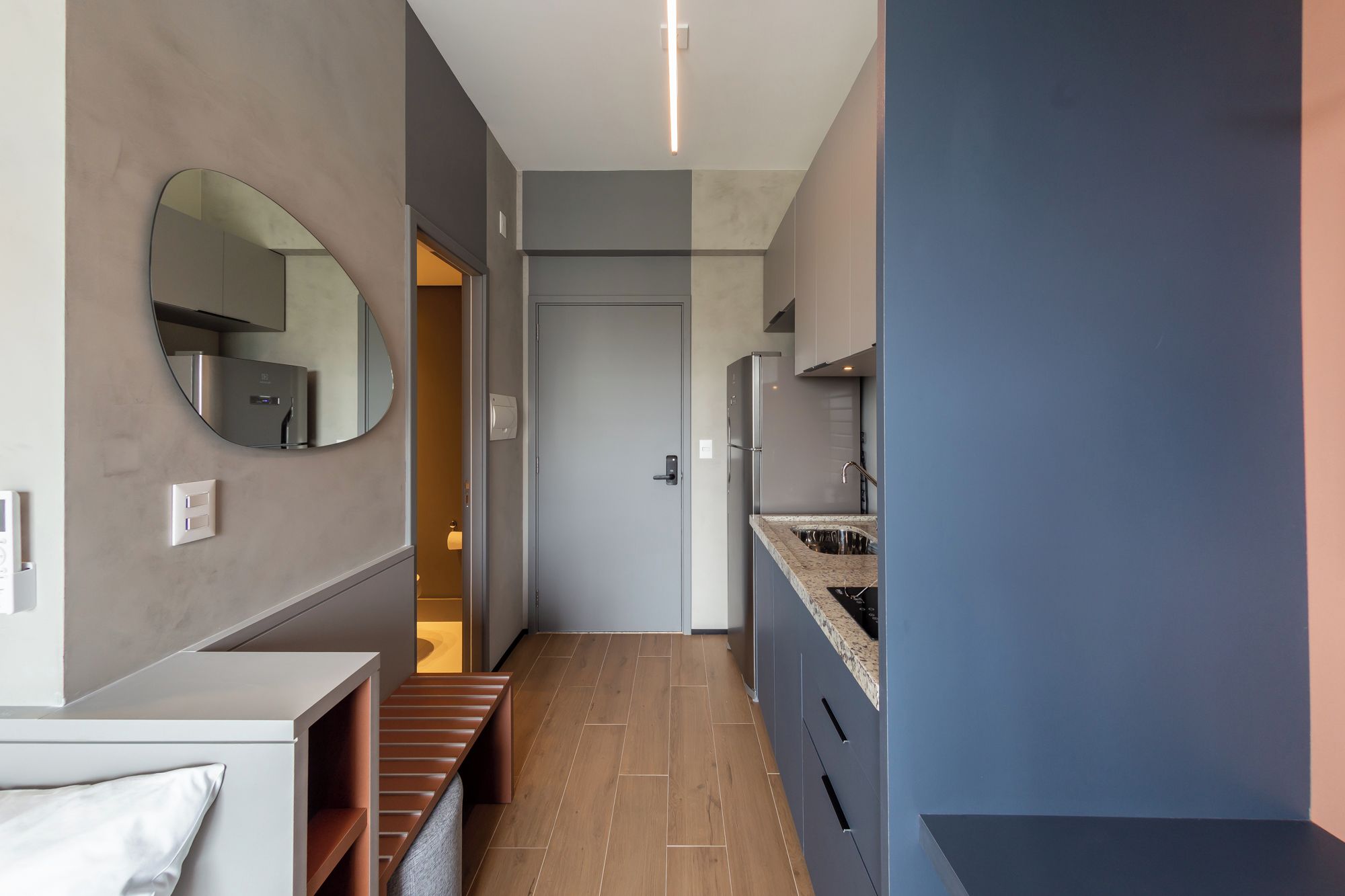 A modern kitchen with a built-in oven, a sink, and a countertop.