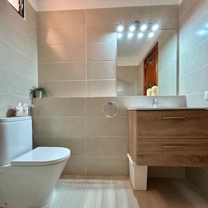 A bathroom with a toilet, sink, and shower area. - Vacation Home 'Apt with Ocean View San Blas K104' with Wi-Fi (Golf del Sur)