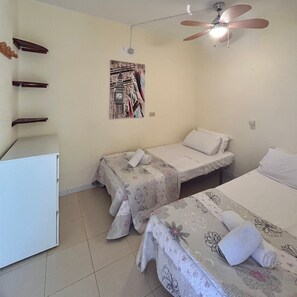 A hotel room with two beds, a ceiling fan, a small table, and a wall-mounted clock. - Vacation Home '1 Bedroom Apartment Green Park K001' with Shared Pool and Balcony (Santa Cruz de Tenerife)