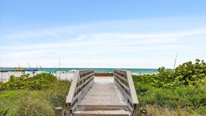 A wooden boardwalk leading to a beach with clear skies. - 2nd Floor OceanView Home Steps to Beach - Shared Pool & Putting Green - On-Site Parking (Bradenton Beach)