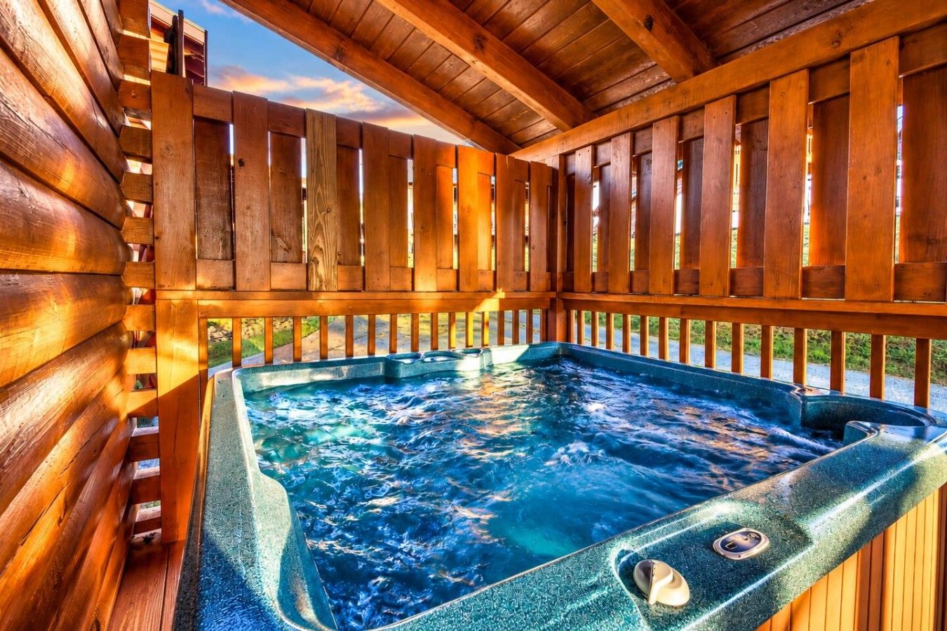 A wooden deck with a hot tub.