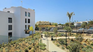 A modern building with multiple windows and a rooftop antenna. - Stylish apartment with access to pool, gym & padel (Mijas Costa)