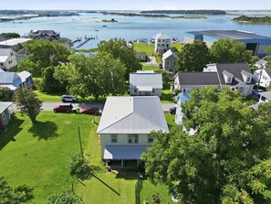 A residential area with houses, a dock, and a body of water. - Historic Swansboro Retreat | Water Views + Backyard with Pizza Oven (Swansboro)