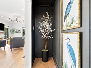 The thoughtfully curated artwork creates an inviting arrival moment, setting the tone for your stay with its serene coastal-inspired palette and elegant design. - Historic Swansboro Retreat | Water Views + Backyard with Pizza Oven (Swansboro)