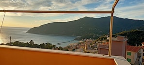 Une ville côtière avec des bâtiments, une vue sur la mer et une montagne en arrière-plan.