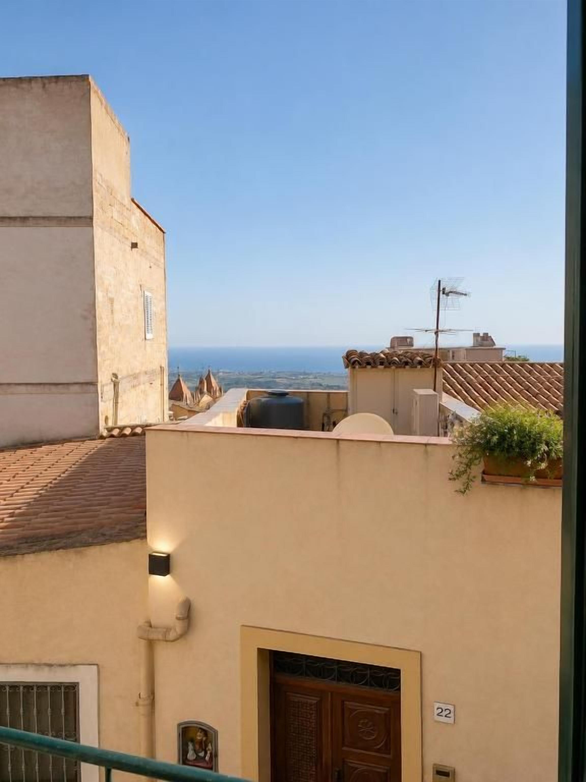 A building with a number 22 sign, a door, and a view of the sea.