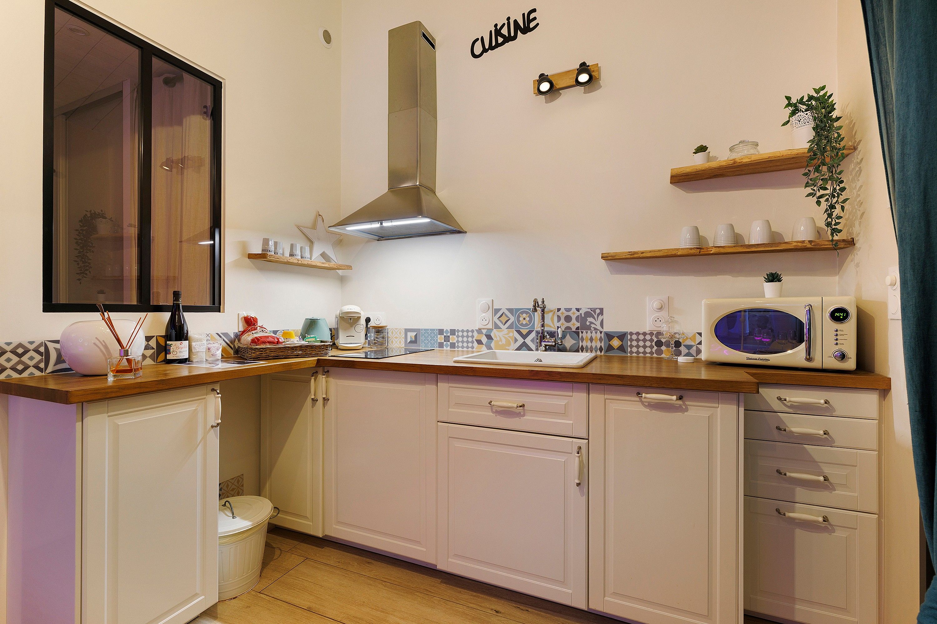 A compact kitchen with a microwave, a coffee maker, and a sink.
