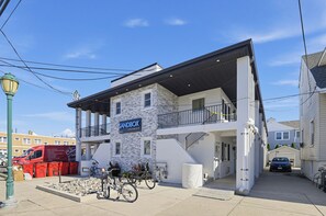 A modern building with a sign reading 'SANDBOX APARTMENTS.' - Sandbox and Sunshine 8 (Margate City)