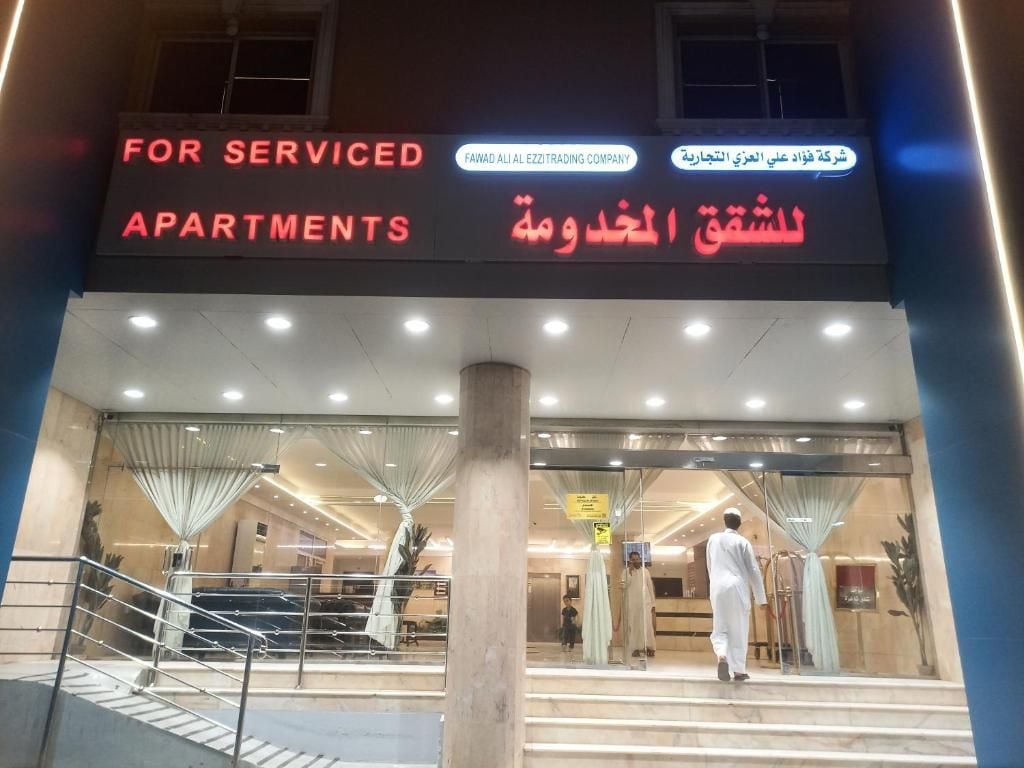 A hotel entrance with a sign indicating serviced apartments.