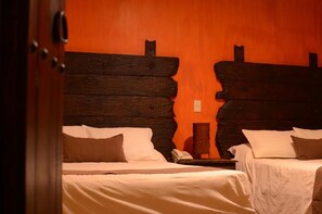 A room with two beds, wooden headboards, and a telephone on a nightstand. - Hotel Boutique Tierra Magica (Tequila)