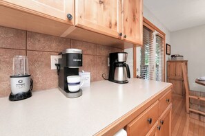 A kitchen with a coffee maker, a blender, and a coffee pod holder. - Chill at Lakefront Lodge!  Clean, Serene, Comfort (Branson West)