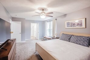 A bedroom with a bed, a desk, a chair, a ceiling fan, and a window with curtains. - 4 Bed in Private Community w/Fenced Yard (Lebanon)