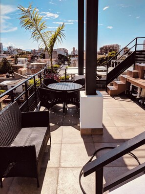 An outdoor patio with a round table and chairs, a sofa, and a staircase. - Unparalleled, 3-Bedroom Luxury. Terraces, Dipping Pool. In the Zona. (Puerto Vallarta)