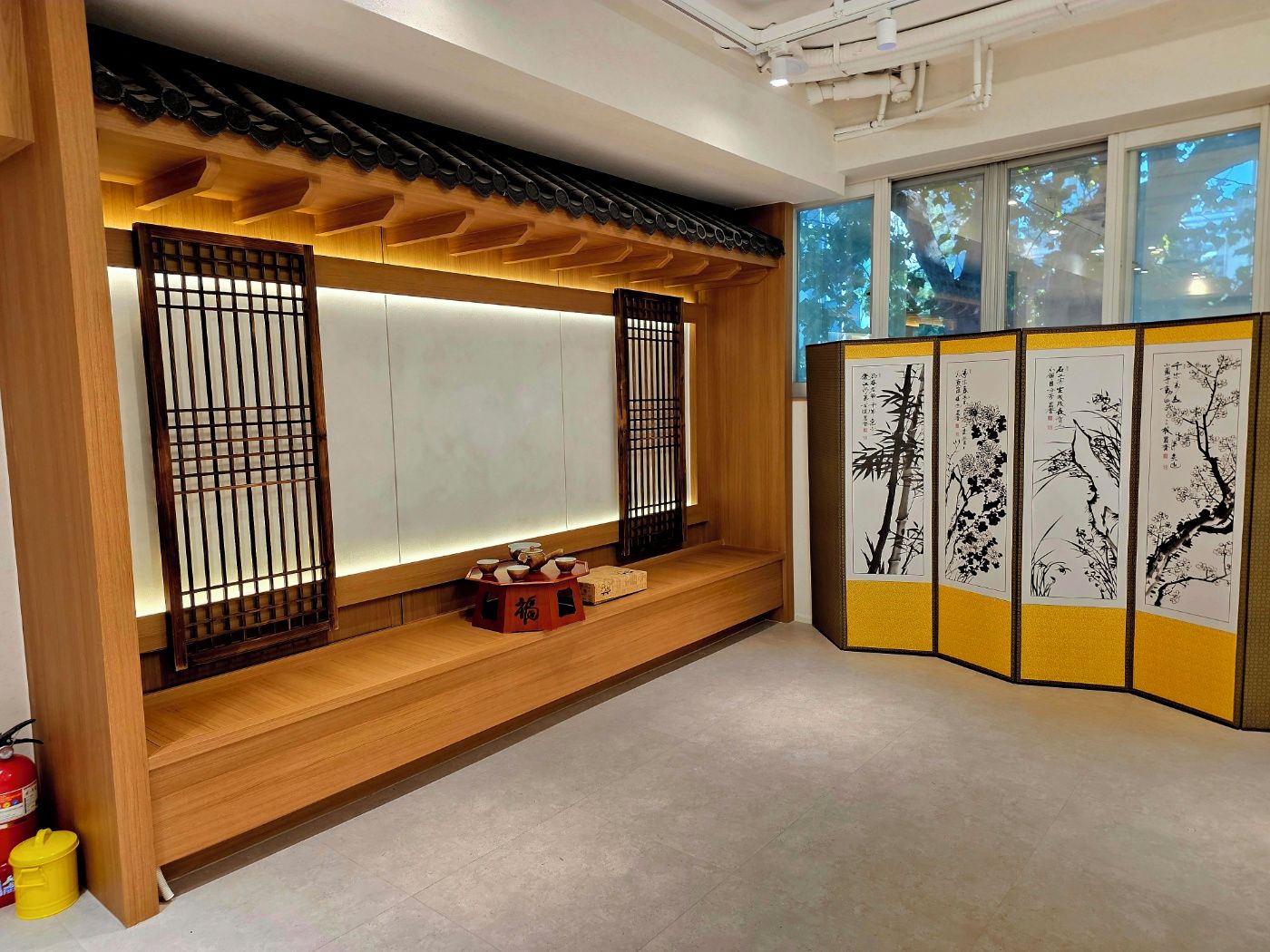 Una habitación japonesa tradicional con suelo de tatami, un mampara de papel shoji y una puerta corredera.