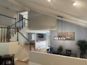 A multi-level home interior with a staircase, dining area, and living space. - Spacious 4-bedroom house in Castle Pines Cul de sac with walk out basement (Castle Pines)