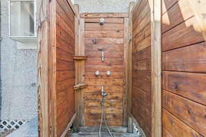 An outdoor shower made entirely of warm, natural cedar wood awaits after your beach days or hikes, adding a touch of rustic charm to your stay.