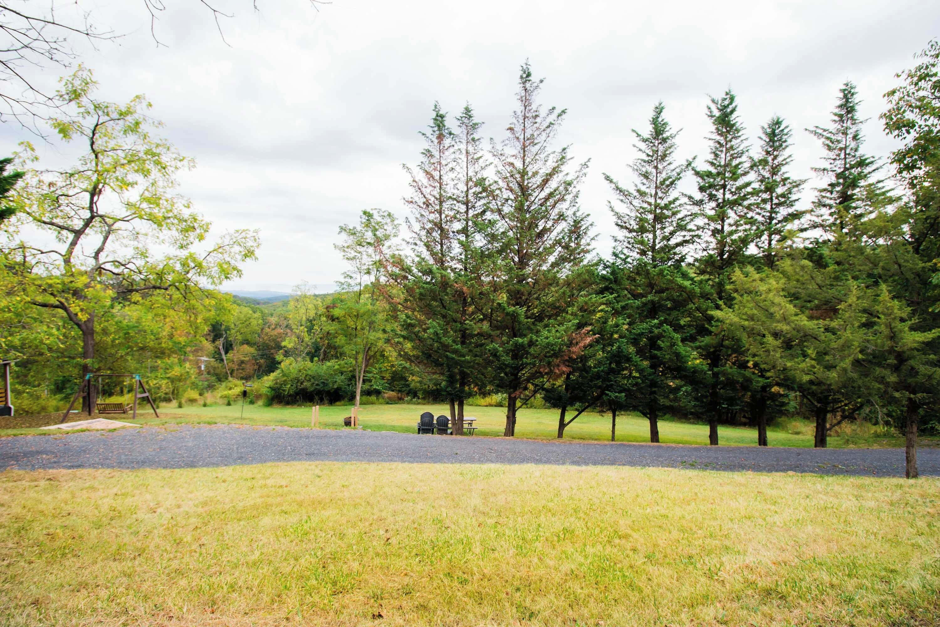 A park with a playground, picnic tables, and a grassy area.
