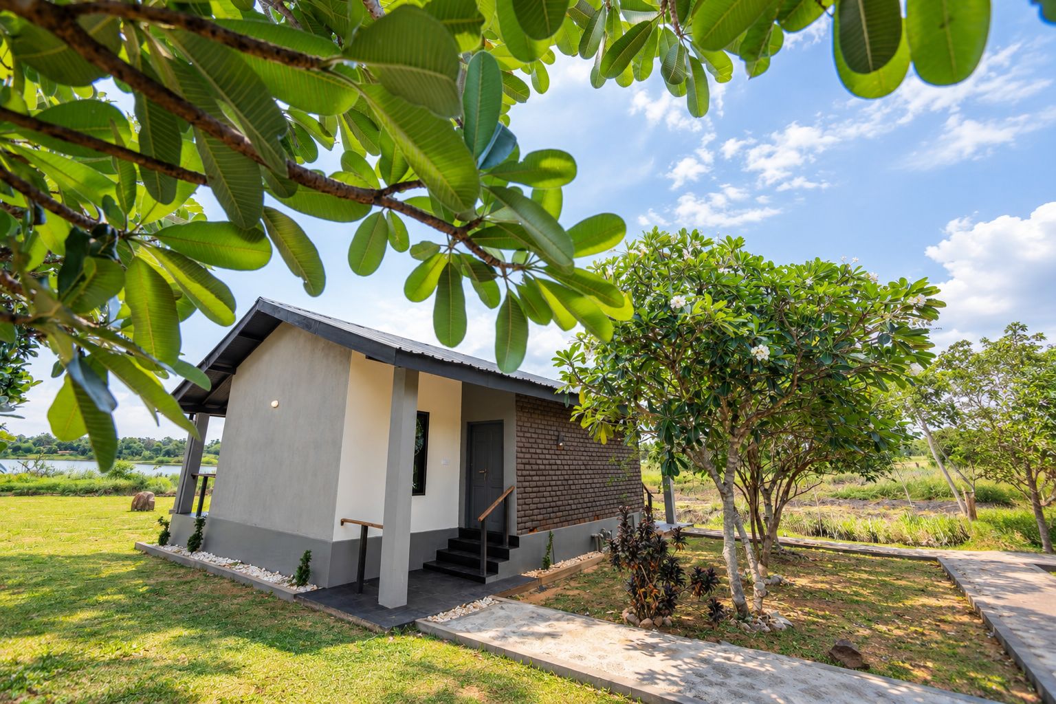 A modern house with a flat roof, a small porch, and a staircase leading to the entrance.